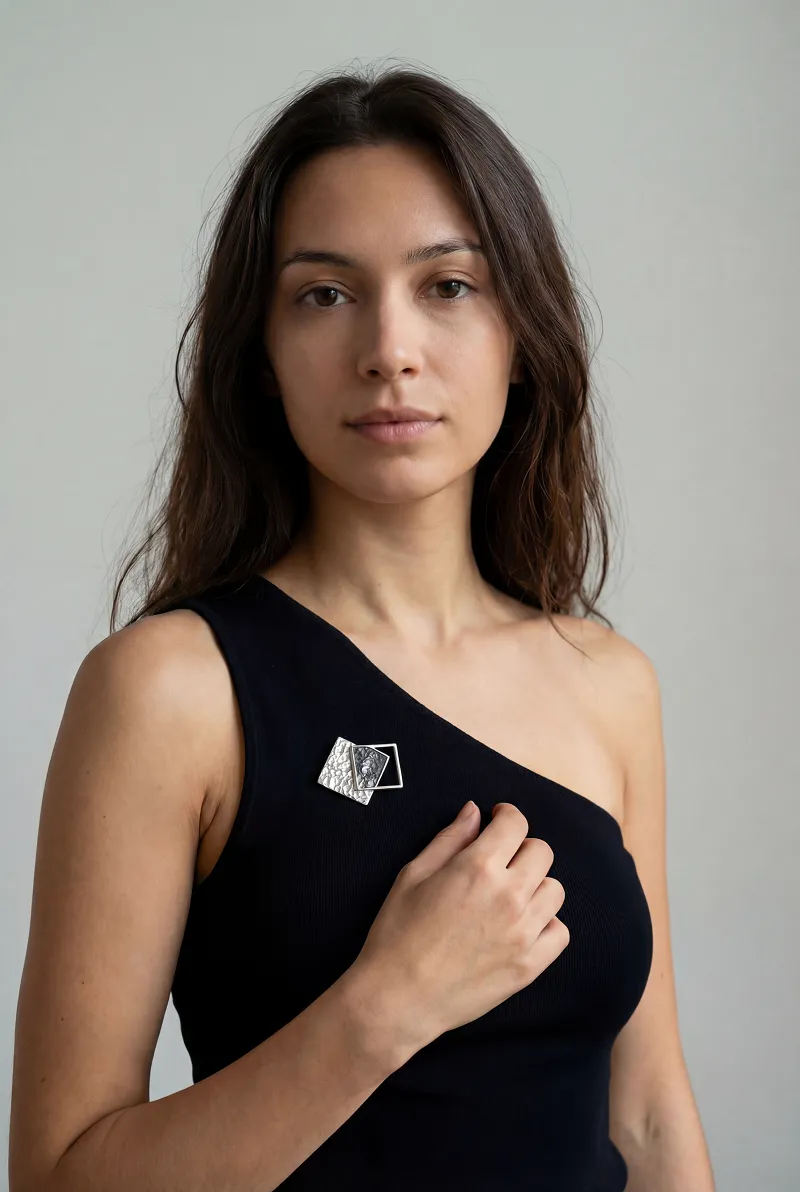 Geometric brooch on dress